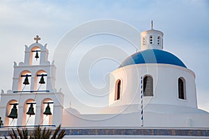 beautiful Oia town on Santorini island, Greece. Traditional white architecture and greek orthodox churches with blue domes over