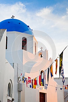 beautiful Oia town on Santorini island, Greece. Traditional white architecture and greek orthodox churches with blue domes over