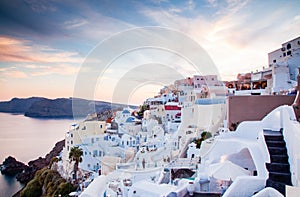 beautiful Oia town on Santorini island, Greece. Traditional white architecture and greek orthodox churches with blue domes over