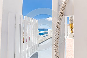 Beautiful Oia town on Santorini island, Greece. White entrance and stairs with sea view, wonderful scenery, vertical travel