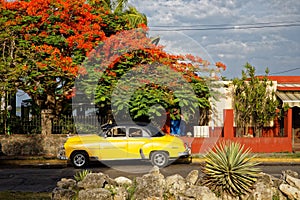 Beautiful old american car in front of colorful house in Cienfuegos in Cuba