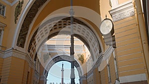 Beautiful old arch with view of monument. Action. Beautiful corridor of street arch of ancient building. Architecture of