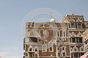 Beautiful old building under the sunlight and a blue sky in Sana'a, Yemen