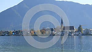 Beautiful old church in vibrant place on the background of the Bavarian Alps on the shore of Lake Tegernsee