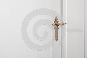 Beautiful old door handle on white dooor