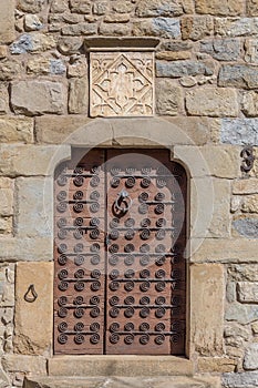 Beautiful old door in a stone house in Spanish ancient village Sant esteve den Bas in Catalonia