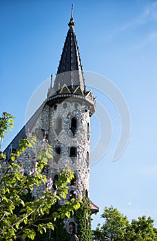 Beautiful old fairy-tale castle near Burgas, Bulgaria. Tower of the castle, green flower garden