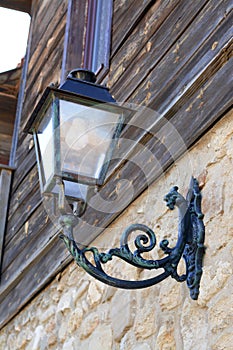 Beautiful old fashioned street lamp on wall of building