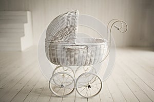 Beautiful old fashioned white pram in white room