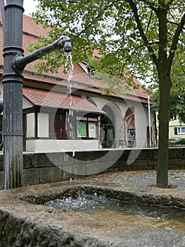 Large half-timbered house behind a fountain