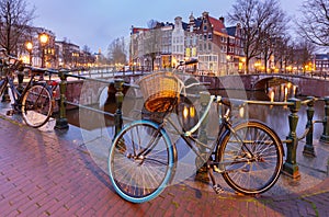 Beautiful old houses on the city waterfront of Amsterdam at sunset.