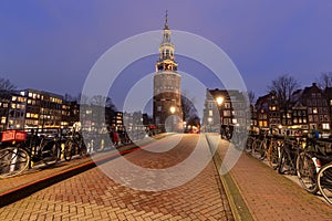 Beautiful old houses on the city waterfront of Amsterdam at sunset.