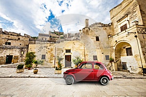 Beautiful old Italian scene. Vintage red small car.