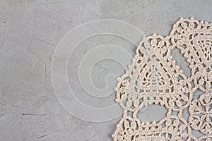 Beautiful old napkin embroidery of beige thread handmade on concrete rough background