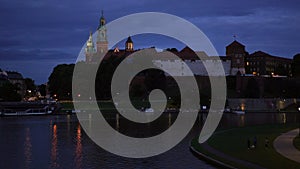 Beautiful old royal Wawel Castle on the banks of Vistula river in the evening,night.Main historical landmark of Krakow, a popular