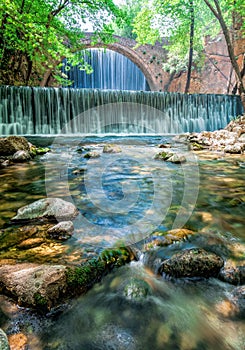 Beautiful old stone bridge between two waterfalls in Paleokaria Trikala Greece