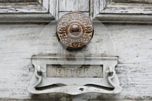 Beautiful old timber door with ornate metal doorknobs photo