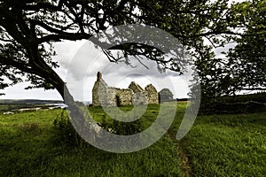 Beautiful old welsh chapel or church, ruin, sky as copyspace top, framed by tree