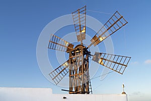 A beautiful old windmill in Fuerteventura, Canary Islands, Spain, against the blue sky at sunset
