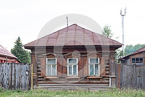 The beautiful old windows with beautifully designed platbands window on an old wooden house in the city of Tula