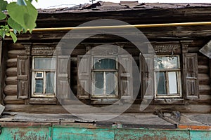 The beautiful old windows with beautifully designed platbands window on an old wooden house in the city of Tula