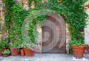 Beautiful old wooden door decorated with flowers, Italy