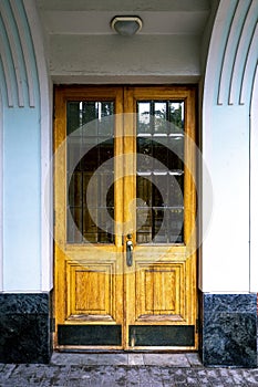 Beautiful old wooden door with glass and panels in a classic style
