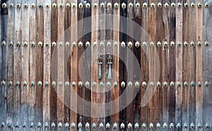 Beautiful old wooden door with iron knock ornament