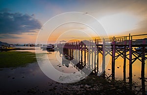 Beautiful old wooden pier, bridge over sea for fishing and walking photo