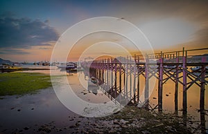 Beautiful old wooden pier, bridge over sea for fishing and walking photo