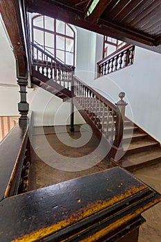 Beautiful old wooden staircase with ornamental handrails leading to the upper floors of the house