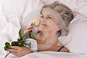 Beautiful older woman resting in the bedroom