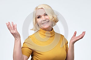 Beautiful older woman in yellow sweater smiling
