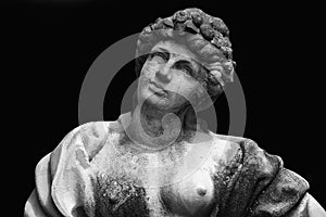 Beautiful Olympic goddess of love in antique mythology Aphrodite (Venus) Fragment of ancient statue on black background