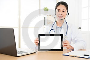 Beautiful online doctor showing tablet computer