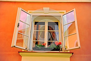 Beautiful open window in orange stone house