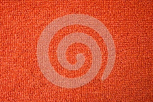 A beautiful orange natural-cotton towel background. Closeup of the grapefruit colored soft fiber texture