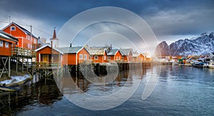 Beautiful orange rorbu in overcast sunset. Fishing village