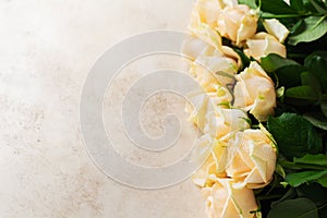 Beautiful orange roses over a light concrete background. Horizontal composition. Text for congratulations on Valentines Day