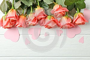 Beautiful orange roses with pink hearts on white background