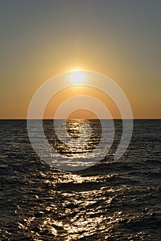 Beautiful orange sunset in the black sea with sun reflection in the city of Gelendzhik, Russia