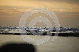 Beautiful orange sunset over the Black Sea. Evening sea with waves. Focusing in the center of the frame.