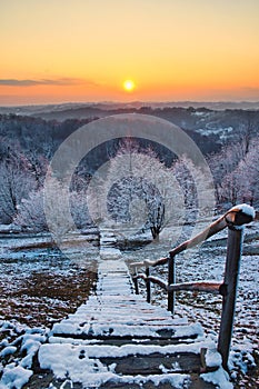 Beautiful orange sunset scenery over hills and stairs that leads into the forest in Croatia, hrvatsko zagorje