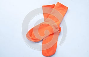 Beautiful orange two cotton socks isolate on a white background