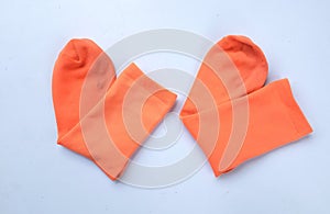 Beautiful orange two cotton socks isolate on a white background