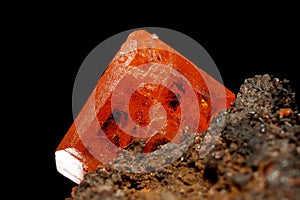 Beautiful orange wulfenite crystal on brown gossan matrix with scattered calcite crystals