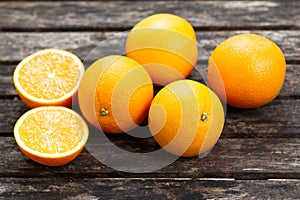 Beautiful Oranges Fruit Full and Sliced on old wooden table. rich with vitamins. background, texture