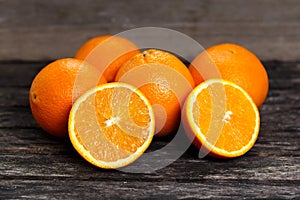 Beautiful Oranges Fruit Full and Sliced on old wooden table. rich with vitamins. background, texture