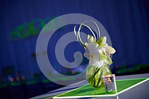 Beautiful orchid cocktail flower arrangement on lucite table set up for a party photo