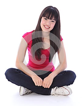 Beautiful oriental teenager girl cross legged photo